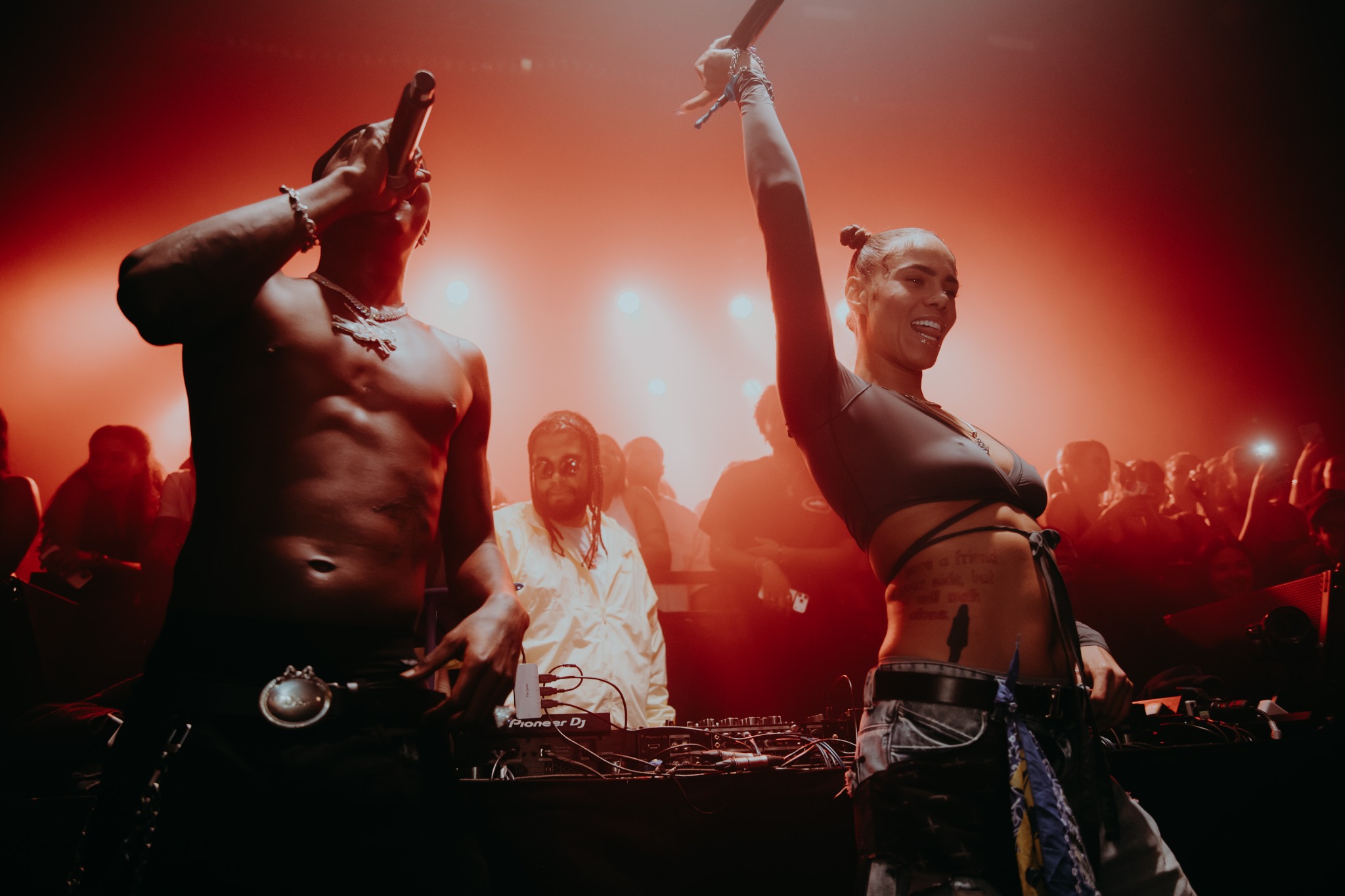 Skillibeng and America Foster performing together under red stage lighting at KOKO.